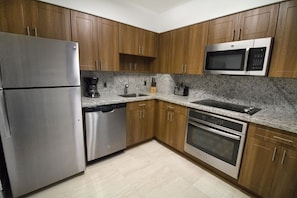 Fully equipped kitchen with a microwave, stove, oven and fridge. All utensils, plates and glasses are provided