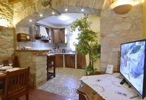 The dining area with satellite TV and access to the equipped kitchen.