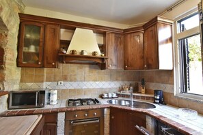 The kitchen equipped with oven, dishwasher, microwave, stove.