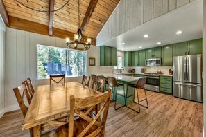 Many family memories will be made at the dining table for 6 beneath the rustic wagon wheel chandelier. Plus, there are bar stools to seat 4 more at the kitchen counter.