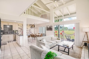 Spacious living area with high vaulted ceiling