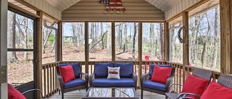 Enjoy coffee on the screened in porch that's homey like a cabin.