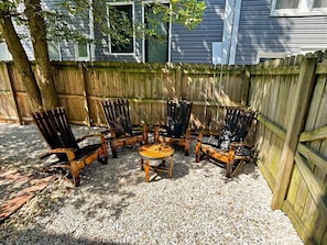 Sit back and relax on the pebble stone patio in our custom-made bourbon barrel Adirondack chairs. 