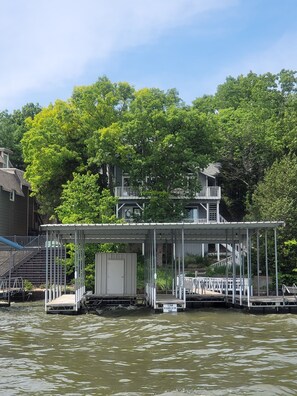Back of house view of boat dock and decks