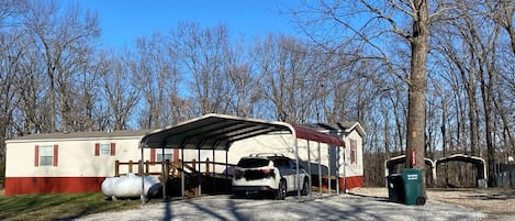 Large driveway with covered parking.