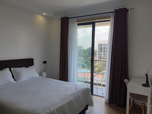 Master bedroom opening up to a balcony. The queen bed measures 60"X80"/152×203cm