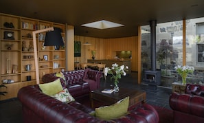 Living area with view to dining table and kitchen