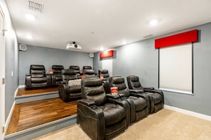 Movie theater has 10 leather power recliners with stadium seating