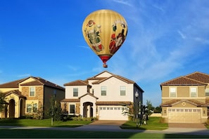 Hot air balloon overhead, a green space in the front and no rear neighbors