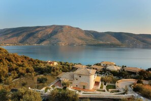 Recline as you watch the sun slowly sink below the Ionian Sea.