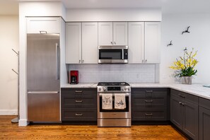 Full kitchen with drip coffee machine.