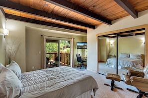 A cozy and well-appointed bedroom with natural light and comfortable bedding.
