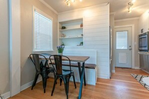 Enjoy meals in this inviting dining room, featuring beautiful built-in shelving and a warm, homey atmosphere with a charming wood dining table.