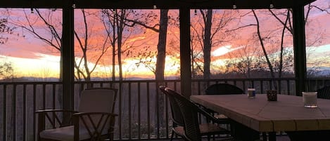 Sunset over distant mountains from screened porch, November 2021