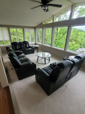 Sunroom with large bay windows overlooking the lake w/ new power recliners