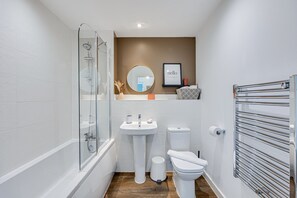 Bathroom with a shower over bath and complimentary toiletries provided.