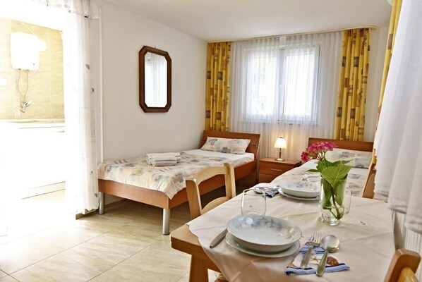 The bedroom and the adjoining dining area, access to the kitchen.