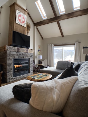 Cozy living room with huge sectional and fireplace.