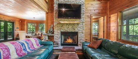 Living room with gas fireplace and large screen television.  Plenty of space.
