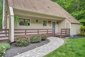 Welcoming entrance with lush greenery and clear lake views