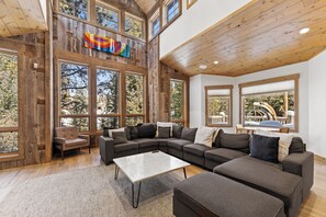 Living area offering large gas fireplace, flat screen TV, incredible lighting and ample seating.