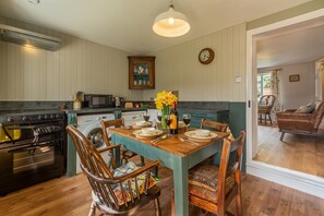 Pond Cottage, Edefield: Kitchen/dining room with electric oven and hob, microwave, dishwasher, fridge,  washing machine and table with seating for four guests