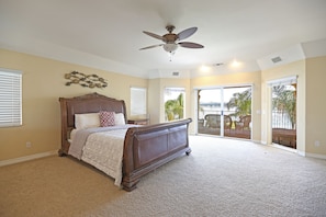 Lakeside house rental features large master bedroom overlooking the lake.