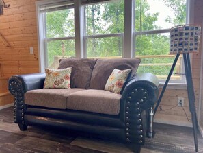 The living features plenty of natural light and a very comfy couch!