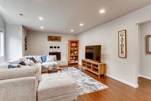Spacious Living room with big couch and 60" Smart UHD TV