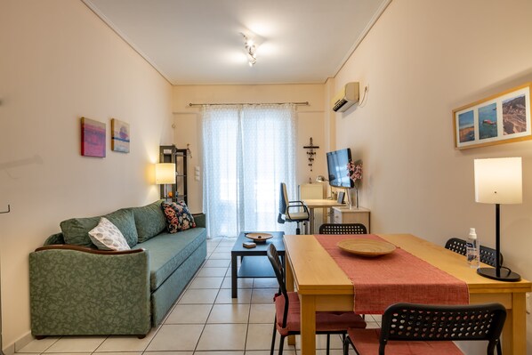 living room with sofa bed and working desk/office chair