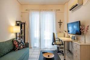 living room with sofa bed and working desk/office chair