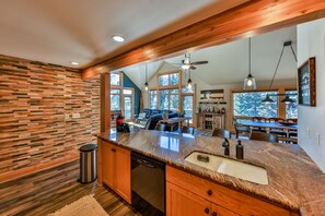 Fully stocked kitchen opens into the main living area.