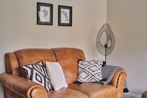 The leather sofa at Bay Tree Cottage, Cotswolds