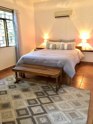 Bedroom one has a comfy queen-size bed, open-air closet, ceiling fan and cold AC