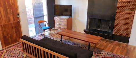 Solid teak coffee table, wood burning fireplace, Roku TV.  