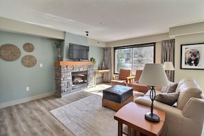 Cozy up by the fireplace in newly renovated living room.