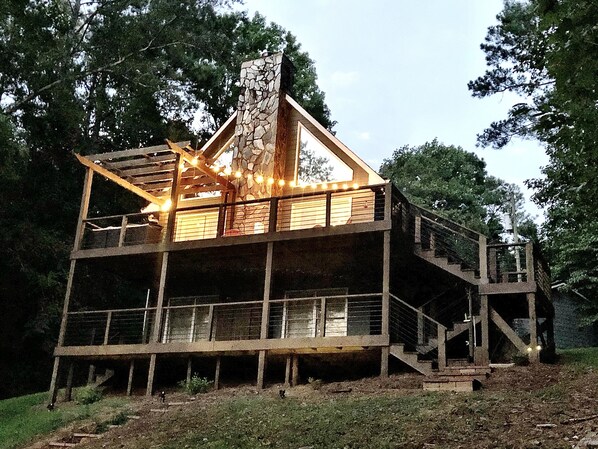 Double deck overlooks private backyard and lake area