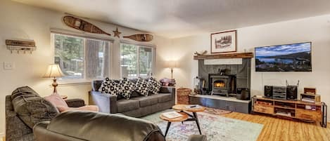 Living room with Roku TV, wood burning fireplace and comfortable seating