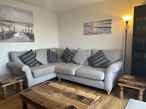 Comfortable & relaxing lounge with patio doors to enclosed child friendly patio