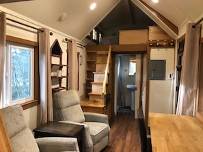 Living space and view of west loft with queen mattress