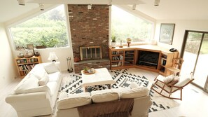 Livingroom looking towards large picture windows and deck