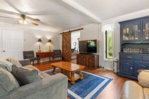 Main living area includes comfortable seating and a Smart TV