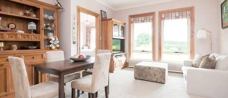 The open living-dining space boasting plenty of natural light