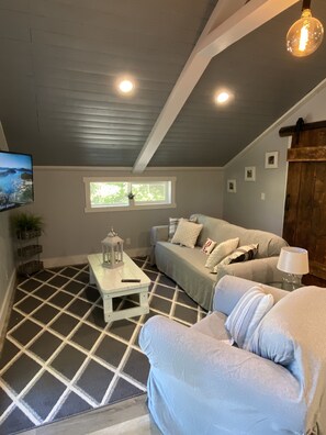 Vaulted ceiling makes the living room feel more spacious.