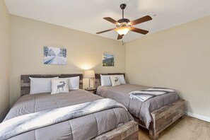 Bedroom #3 with two queen beds, a tv and a closet. 