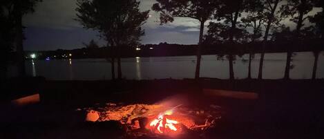 Real wood fire pit overlooking the lake. 