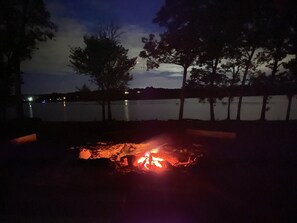 Real wood fire pit overlooking the lake. 