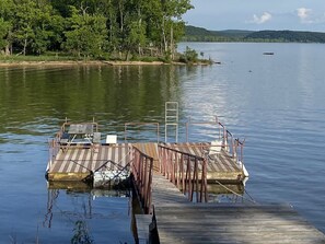 Dock with a diving board, swim ladder and a picnic table. 
