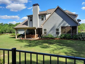Back of house, covered back porch w/tv