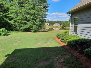 Back yard with garden and pond